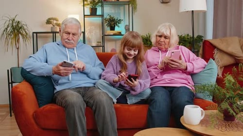 Three Generations of Family Using Smartphones