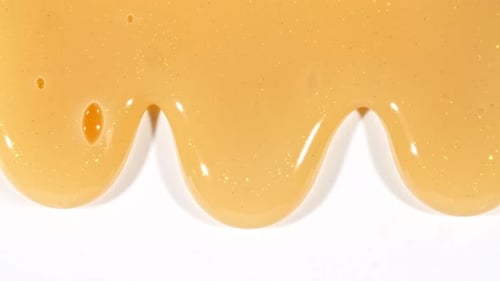 Yellow Cosmetic Gel Fluid With Molecule Bubbles Flowing On The Plain White Background Liquid Cream