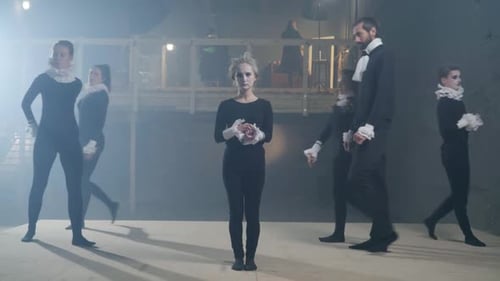 Actors Performing on Stage in Dramatic Setting