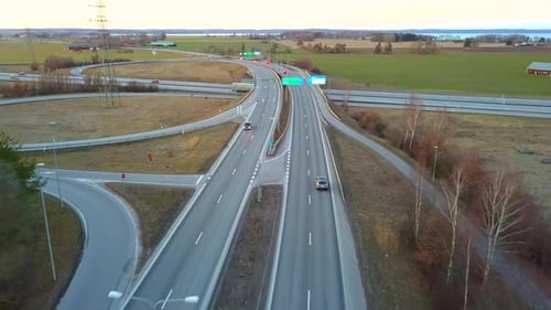 Aerial View of Freeway Intersection with Moving Traffic Cars