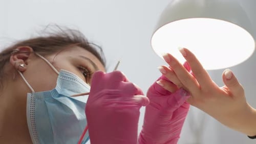 Manicurist Doing Nail Art in Beauty Salon