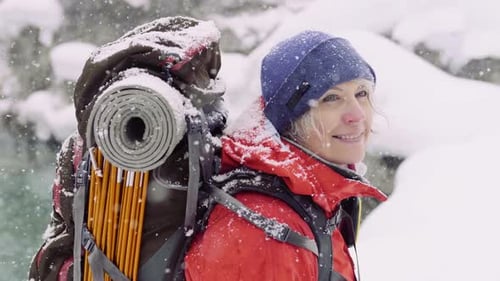 Woman Hiking in Snow Covered Mountain Landscape