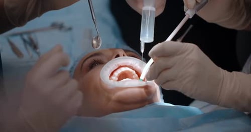 Dentists Does Oral Surgery in Dental Clinic