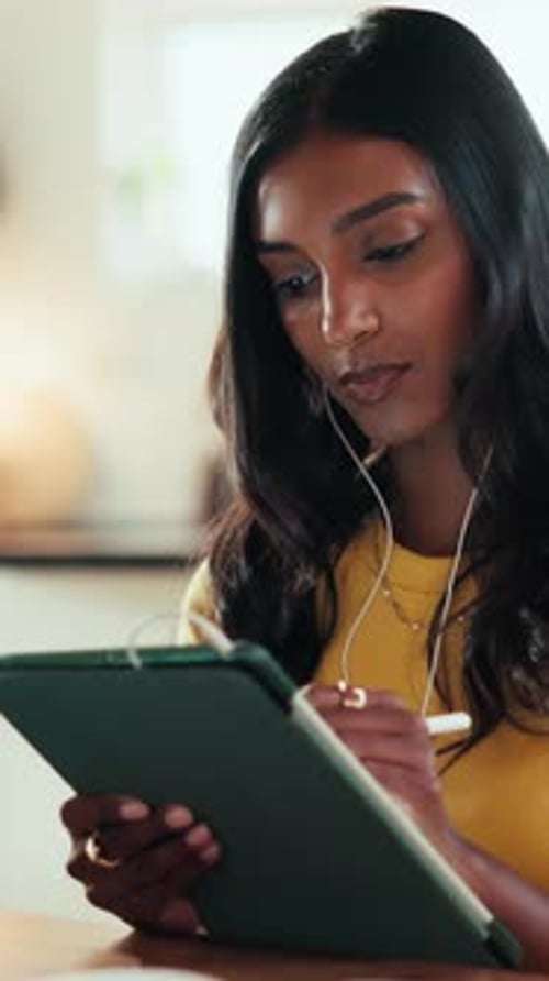 Earphones, tablet and writing with graphic design student in home for education or learning
