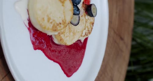 Tasty Syrniki Pancakes Topped with Berries and Cream
