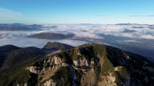 Aerial View of Mountainous Landscape with Forests Valley Full of Fog