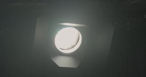 Close up on ETC Desire D40 LED light switching on and off facing camera in overhead studio rigging