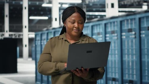 Programmer in Data Center Using Laptop to Upgrade Systems