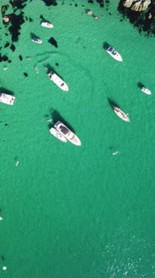 Aerial Vertical View of Seascape with Crystal Clear Azure Sea and Rocky Shores Yachts in a Beautiful