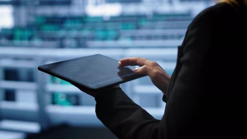 Woman Works on Tablet in Modern Office
