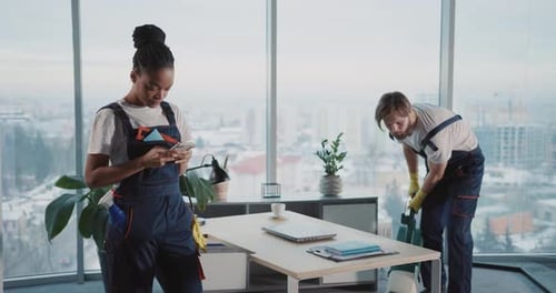 Caucasian Young Man in Cleaning Uniform Doing Cleanup Service in Corporate Office Lazy Afroamerican