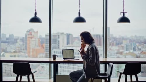 Furious Manager Calling Phone Gesturing Emotionally at Office Panoramic Window