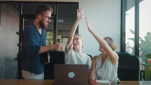 Team High Five in Modern Office Space