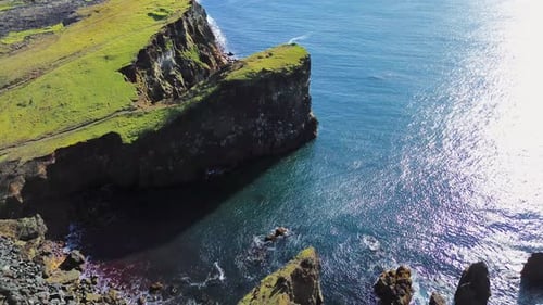 Aerial drone view of dramatic sea cliffs rising above the North Atlantic Ocean. Steep volcanic rock