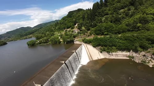 Waterfall Over Dam in Lush Japanese Landscape