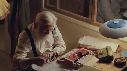 Senior Writer Crossing Out Text, Crumpling Paper and Throwing It Away