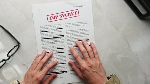 Soldier Reads Secret Documents Top View