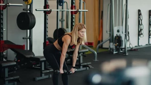 Active Woman Athlete Practicing Forward Bends with Dumbbells Working Out at Gym Tracking Shot Free