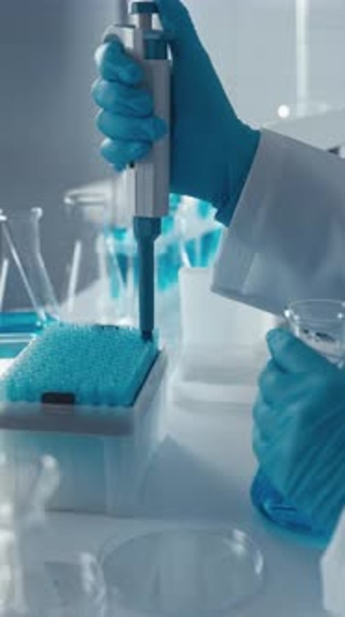 Scientist Using Pipette in Bright Laboratory