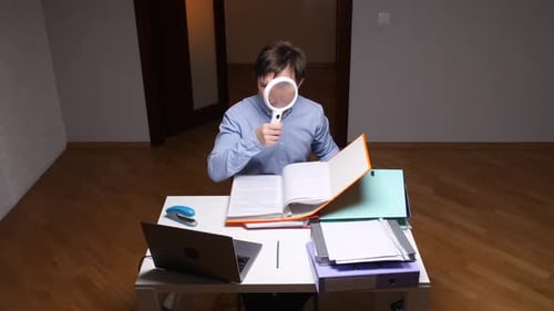 Accountant Examining Documents with Magnifying Glass at Office Desk