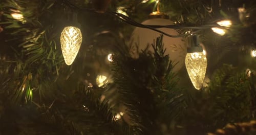A close up slide on Christmas Tree lights and ornaments, bokeh, selective focus, left to right