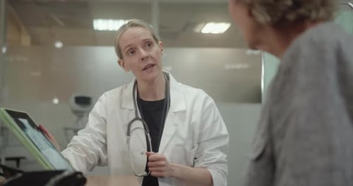 Doctor Discussing Medical X ray in Doctors Office with Senior Patient