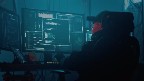 Young Adult Coding at a Futuristic Computer Station