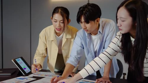 Young business professionals collaborating on data analysis in office. Team discussing financial