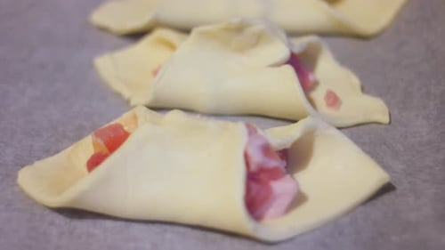Raw pastry, bacon on baking tray