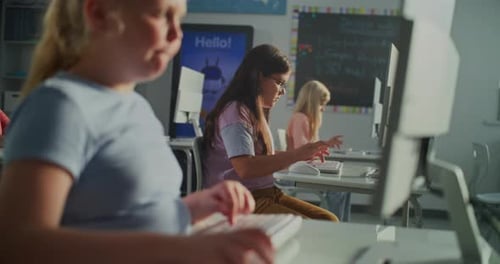 Children using computers in a bright classroom