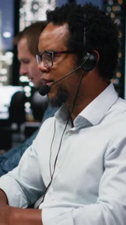 Vertical Video Startup Helpdesk System Administrator in Office Speaking in Headset Mic