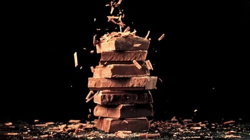 Stacked Chocolate Bars with Falling Chocolate Shavings