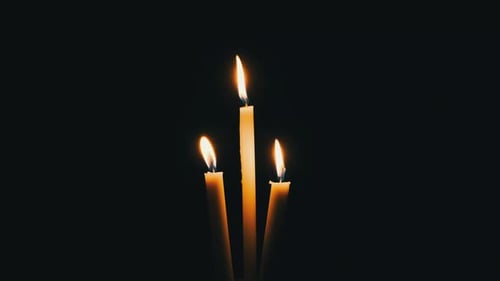 Three Candle Burns on a Black Background