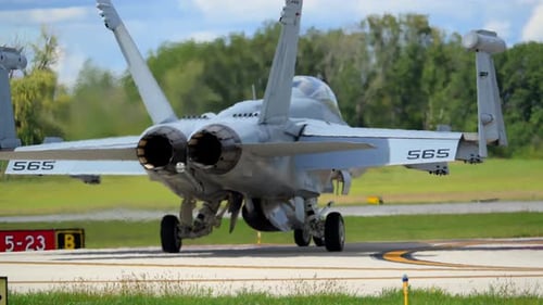 Slow Motion Close Up Rear View of F18 Fighter Jets Heading to Takeoff Runway Showcasing Military