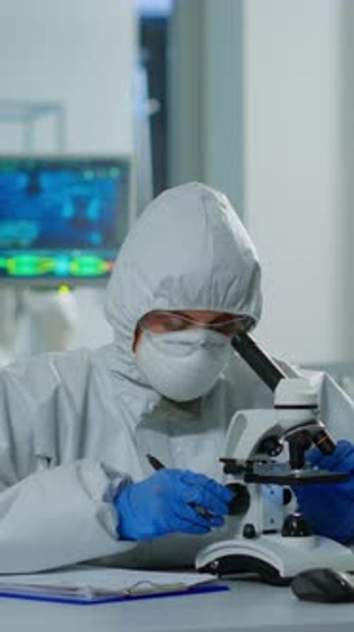 Researcher Using Microscope in a Medical Lab