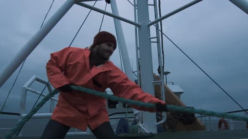 Man Working with Rope on Fishing Boat