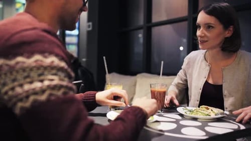 Couple enjoying healthy lunch and drinks at cafe