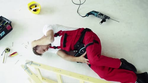 Top View of an Injured Man Lying on the Floor After An