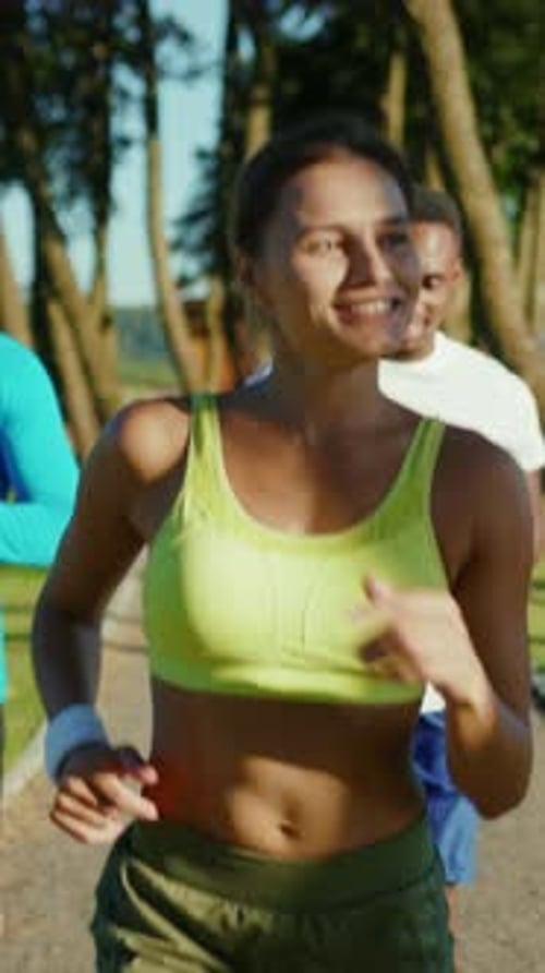 Diverse Group of Young Adults Jogging in Park