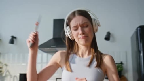Woman Dancing and Cooking in Kitchen
