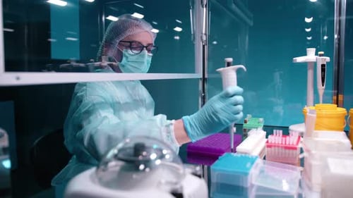 Female Scientist Pipetting Samples in Lab