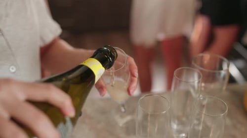Pouring Bubbly Wine at Social Celebration with Friends