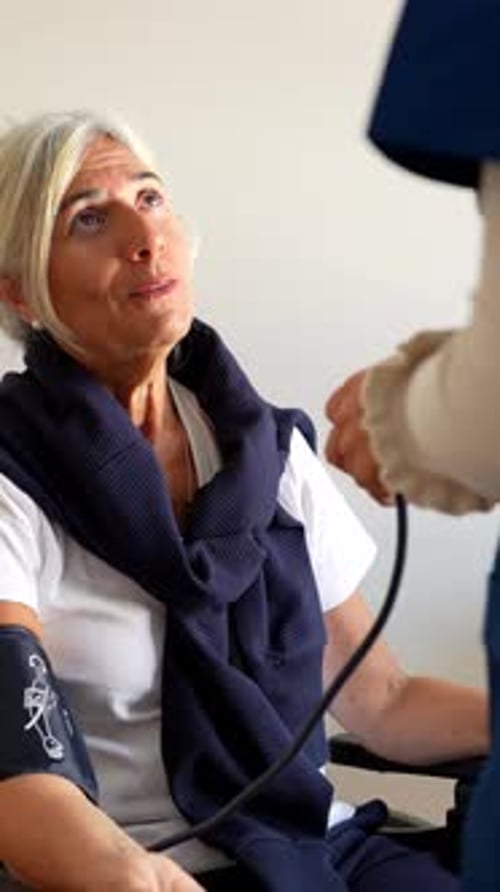 Woman Having Blood Pressure Measured in Medical Setting