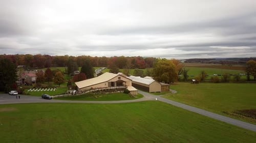 Aerial establishing shot of a converted barn wedding venue in Hamburg, Pennsylvania in the fall