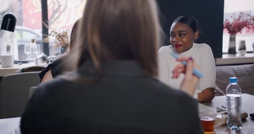 Happy Beautiful Young Genz African Coach Business Woman Talks to Colleagues at Loft Trendy Coworking