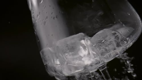 Clear Cold Mineral Water Pouring Over Glass With Ice Cubes Close Up. Clean Liquid Washing Smooth ...