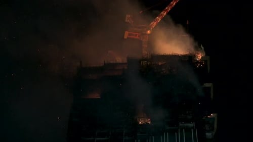 A fire breaks out in a high rise skyscraper office building rooftop in Hong Kong.