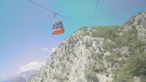 Cable car, funicular. We look up at the mountains and a red funicular passes by.