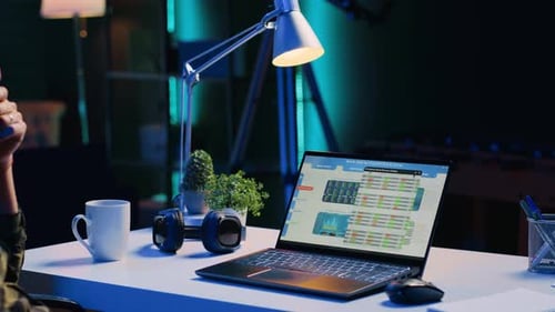 Man Working on Laptop at Desk Late Night