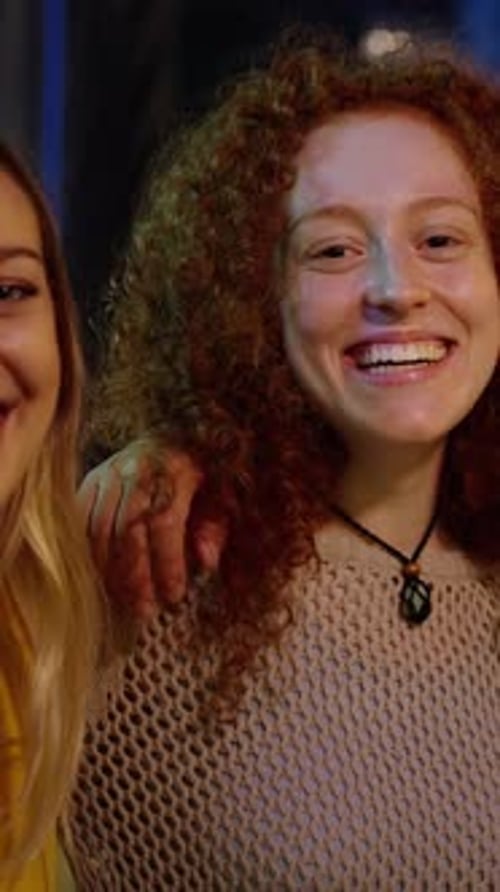 Friends Laughing Together in an Urban Setting at Night